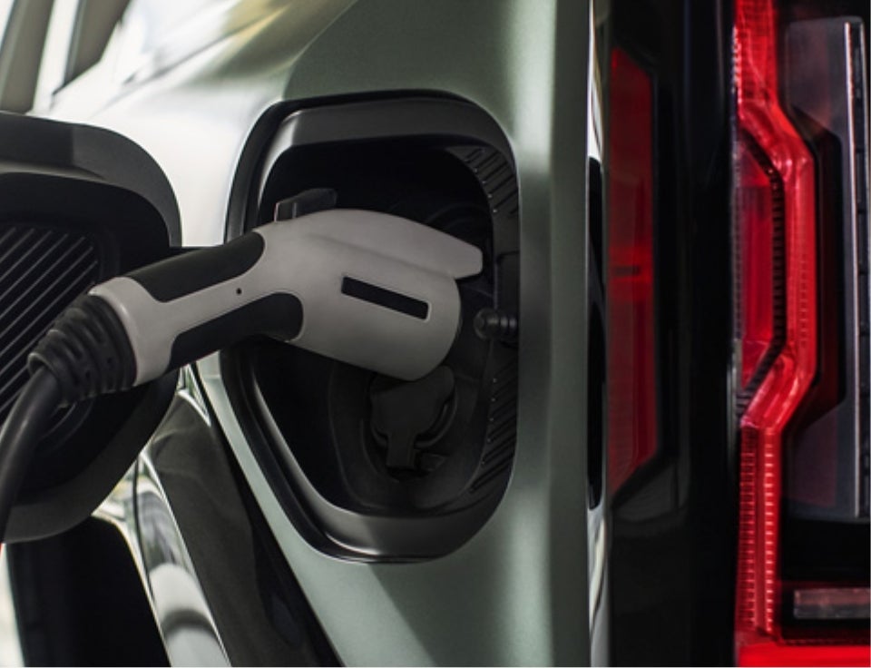 Close up of charging port with charger plugged in on a GMC Hummer EV SUV - Diamond Buick GMC of Alexandria in ALEXANDRIA MN